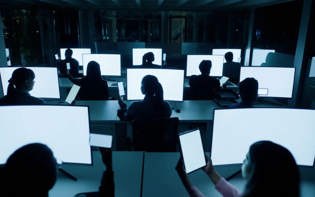 A coordinated team working across multiple screens in a dark operations environment, representing Avionn Automotive’s expanding infrastructure.